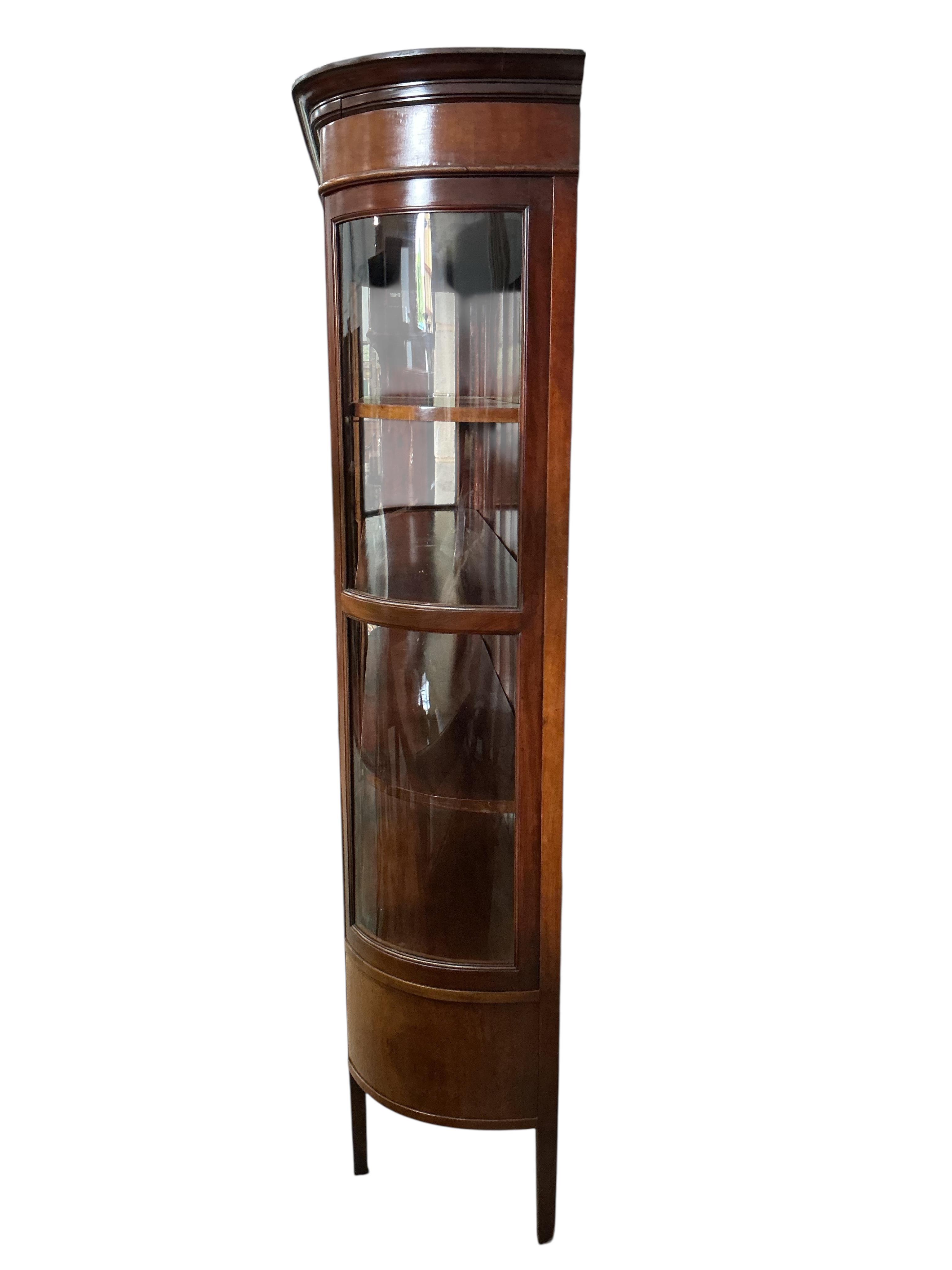 An early 20th century mahogany bookcase with two spare bow glazed door sections, width 145cm, depth 44cm, height 187cm